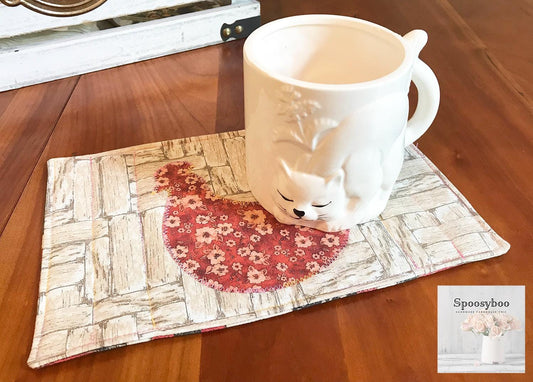 Mug rug used for placing your drink on along with a pastry. has floral applique of a chicken and the background is a rustic wood print on 100% cotton. Lightly quilted. (etsy image id: 6528157486)