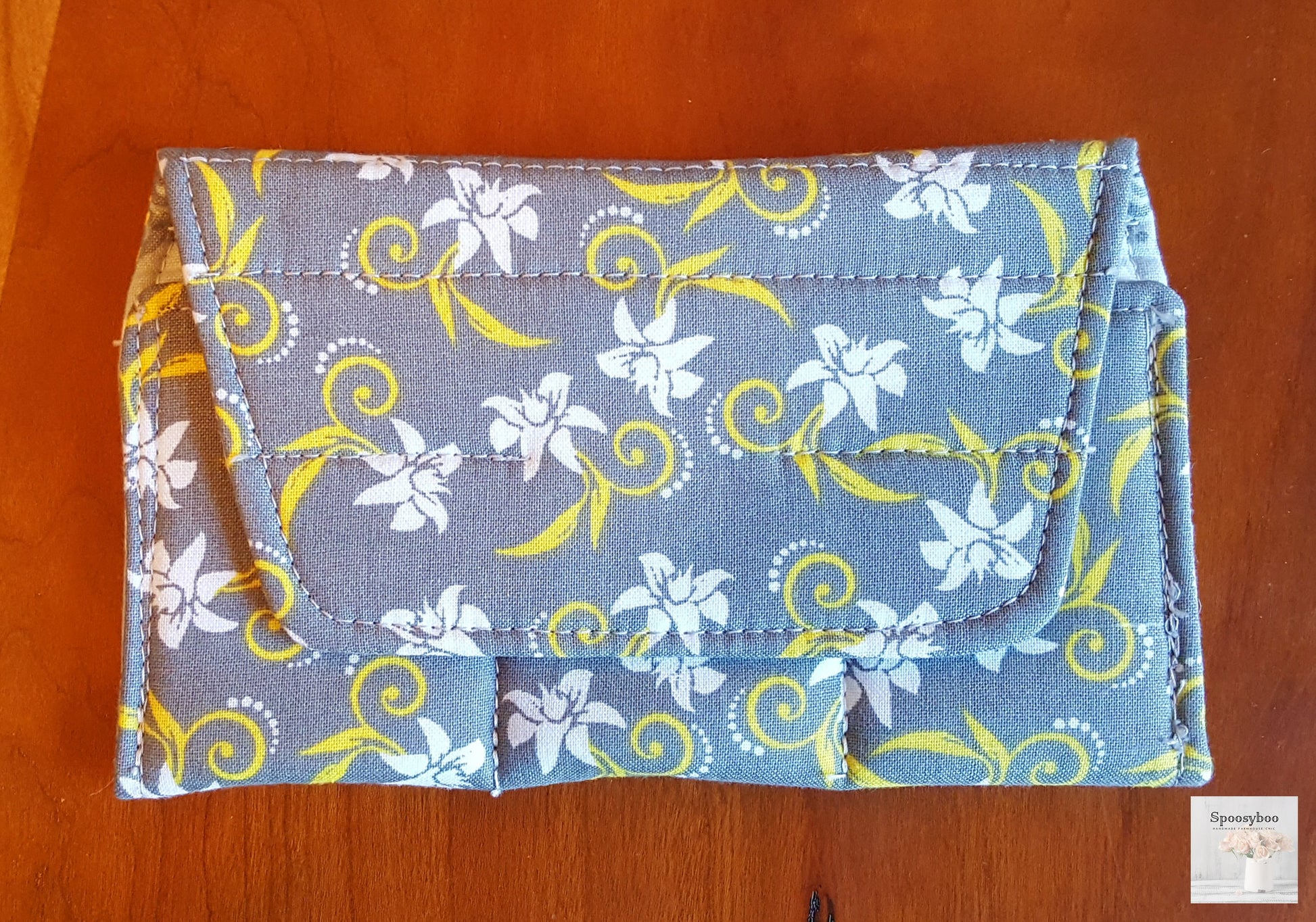 Grey background fabric small bottle pouch fits 3 bottles, features white flowers with yellow stylized swirls (etsy image id: 1690577724)