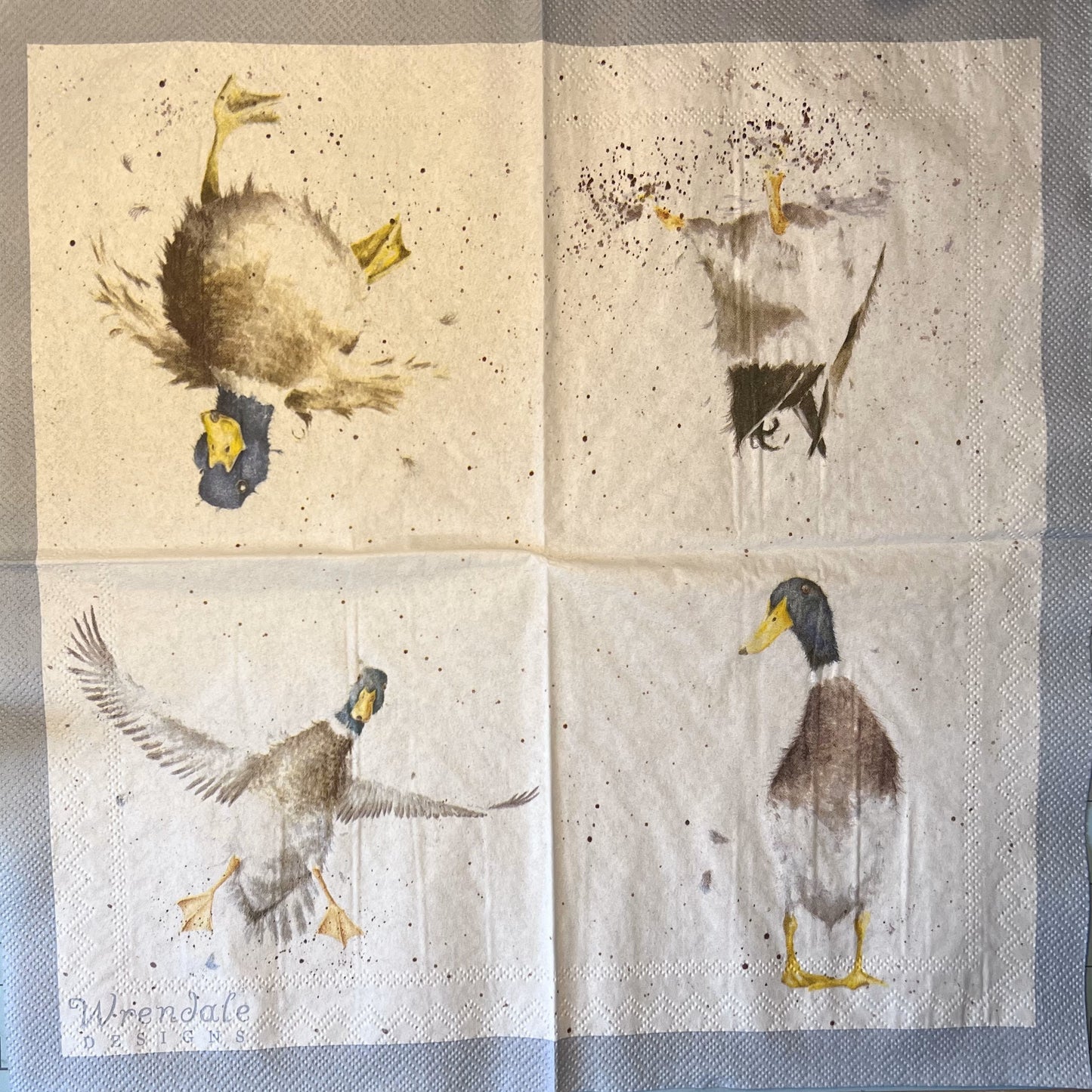 This napkin show it open with all of the different Duck images on it. There are four different ones on this napkin. one with the ducks back to you with its head turned to look at you. One with the duck wings out, one with the duck frolicking. (etsy image id: 4803897364)