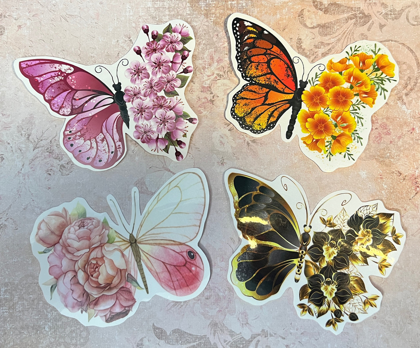 Set of 4 Butterfly stickers, one side of the Butterfly is a butterfly wing and the other side is a floral style wing. There is a pink butterfly, a Monarch butterfly, a pale pink and white butterfly and a gold and black butterfly sticker. (etsy image id: 5603910148)