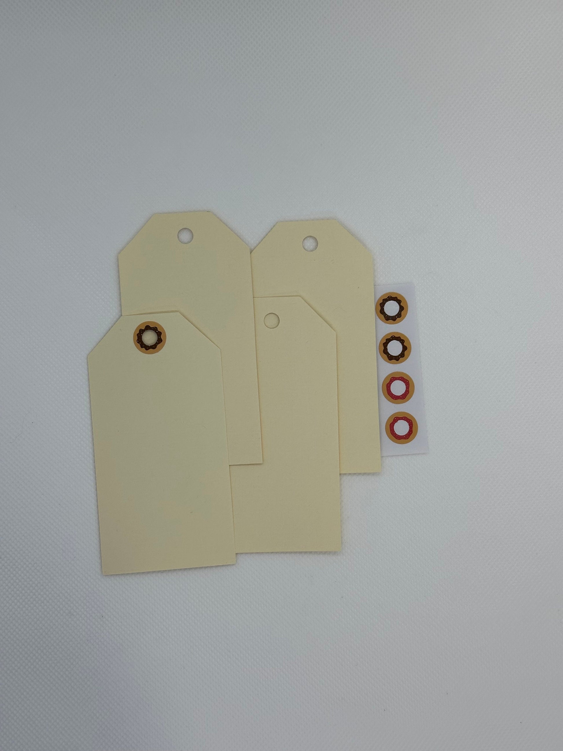 Maila Tags with donut stickers for the tag hole (etsy image id: 5849987182)