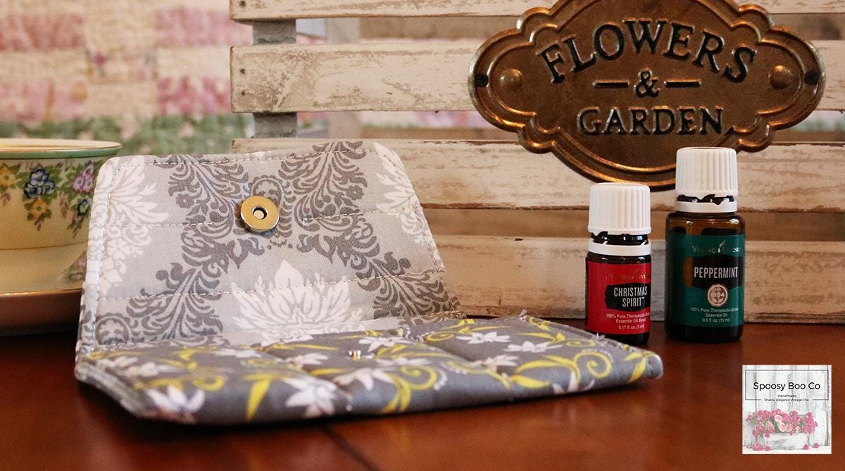 Grey background fabric small bottle pouch fits 3 bottles, features white flowers with yellow stylized swirls (etsy image id: 6576190921)