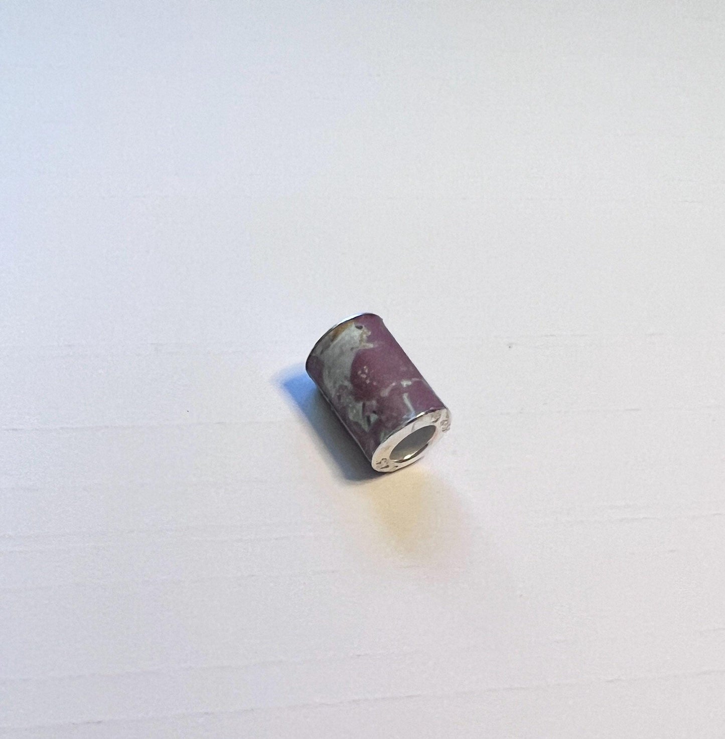 Silver 5mm bead cores for paper bead making, this image shows a unvarnished finished paper bead using the sterling silver bead cores (etsy image id: 7760607386)