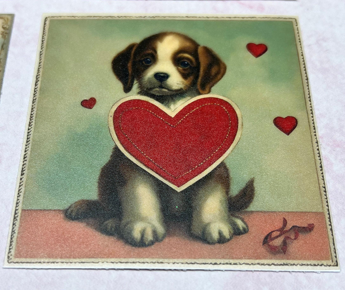 Vintage floppy ear Puppy with big red heart in the middle and a few small red hearts in the background (etsy image id: 7808617601)