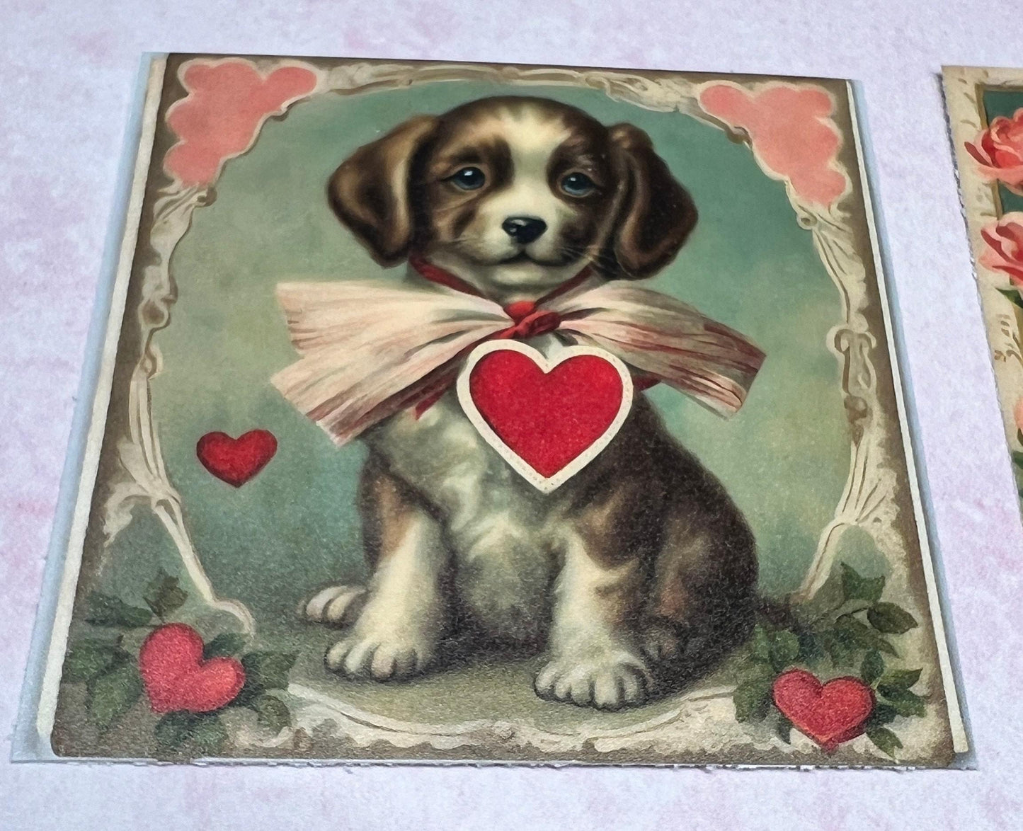Vintage puppy with  big bow and red heart in the middle, inside a oval ornate drawn frame with hearts on the bottom (etsy image id: 7808617629)